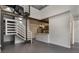 Open floor plan with a modern staircase and view of the adjacent kitchen at 1603 Woodward St # 18, Orlando, FL 32803