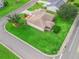 Aerial view of home highlighting the manicured lawn, mature trees, and well-designed landscaping at 1948 Harston Trl, The Villages, FL 32162