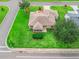 Aerial view of home showcasing well-maintained landscaping, mature trees, and a charming neighborhood at 1948 Harston Trl, The Villages, FL 32162