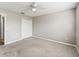 Carpeted bedroom with neutral paint, ceiling fan, and a closet letting in natural light at 1948 Harston Trl, The Villages, FL 32162