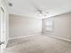 Carpeted bedroom with neutral paint, ceiling fan, and a window letting in natural light at 1948 Harston Trl, The Villages, FL 32162