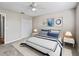 Staged bedroom featuring carpet flooring, a ceiling fan, closet and neutral colored walls at 1948 Harston Trl, The Villages, FL 32162