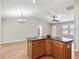 Kitchen island with cabinets and a view of the dining and living areas creates an inclusive living space at 1948 Harston Trl, The Villages, FL 32162