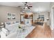 Bright, spacious living room with neutral tones open to the kitchen and dining area at 1948 Harston Trl, The Villages, FL 32162