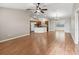 Expansive living area with wood flooring, seamlessly integrates the kitchen and dining spaces at 1948 Harston Trl, The Villages, FL 32162