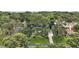 Aerial view of home surrounded by lush trees, highlighted by a border, with a private driveway at 2108 Dogwood Cir, Mount Dora, FL 32757