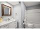 Bright bathroom featuring a vanity with a mirror, toilet, and a shower/tub combo at 2108 Dogwood Cir, Mount Dora, FL 32757
