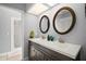 Bathroom with a double sink vanity, shower, and plenty of natural light at 2108 Dogwood Cir, Mount Dora, FL 32757