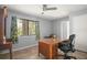 Bedroom with a ceiling fan and a large desk with decorative window trim at 2108 Dogwood Cir, Mount Dora, FL 32757