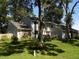Charming two-story home featuring stone accents and lush landscaping at 2108 Dogwood Cir, Mount Dora, FL 32757