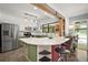 Bright kitchen with white cabinets, green accents, stainless steel appliances, and a view of the pool at 2108 Dogwood Cir, Mount Dora, FL 32757