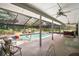 Screened-in pool area with patio seating and views of the backyard at 2108 Dogwood Cir, Mount Dora, FL 32757