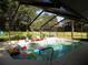 Enclosed pool with a bench and lots of pool toys at 2108 Dogwood Cir, Mount Dora, FL 32757
