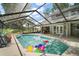 Enclosed pool with an open roof, patio, and a clear view of the sky at 2108 Dogwood Cir, Mount Dora, FL 32757