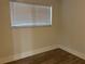 This bedroom features new vinyl flooring and a window with white blinds at 228 Cannon Way, Casselberry, FL 32707