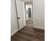 Bedroom with updated vinyl flooring providing an entrance to the kitchen at 228 Cannon Way, Casselberry, FL 32707