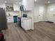 Open-concept kitchen with new appliances, granite countertops, and modern vinyl flooring at 228 Cannon Way, Casselberry, FL 32707