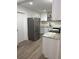 Modern kitchen featuring stainless steel refrigerator, white cabinetry and granite countertops at 228 Cannon Way, Casselberry, FL 32707