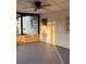 Enclosed porch with gray concrete floor, wood trim and ceiling fan at 228 Cannon Way, Casselberry, FL 32707