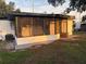 Relax on this screened patio offering an outdoor space, allowing for comfortable enjoyment of the surrounding yard and garden at 228 Cannon Way, Casselberry, FL 32707