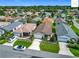 Aerial view of the home features manicured landscaping, driveway, and a garage at 2311 Pine Ridge St, The Villages, FL 32162