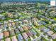 The aerial view shows homes situated on well-maintained lawns with mature landscaping at 2311 Pine Ridge St, The Villages, FL 32162