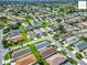 An elevated view of a community boasts a landscape featuring a mix of housing, trees, and ponds at 2311 Pine Ridge St, The Villages, FL 32162