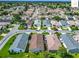 A suburban aerial view reveals a well-organized neighborhood with lush lawns and curved streets at 2311 Pine Ridge St, The Villages, FL 32162