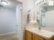 Well-lit bathroom featuring a modern vanity, mirror, and adjacent carpeted room at 2311 Pine Ridge St, The Villages, FL 32162