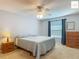 Comfortable bedroom with a ceiling fan, window, and traditional furnishings at 2311 Pine Ridge St, The Villages, FL 32162