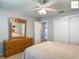 Cozy bedroom featuring a spacious closet and a classic wooden dresser with a large mirror at 2311 Pine Ridge St, The Villages, FL 32162