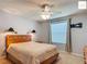 Bedroom with a plush bed, fan, wall lamps, and large window for plenty of natural light at 2311 Pine Ridge St, The Villages, FL 32162