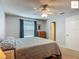 Bedroom with neutral walls, a fan, a window with curtains, and a dresser, offers comfortable living at 2311 Pine Ridge St, The Villages, FL 32162