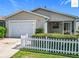 Well-maintained single-story home with attached garage and manicured front yard at 2311 Pine Ridge St, The Villages, FL 32162