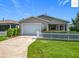 Charming single-story home with a well-maintained lawn and white picket fence at 2311 Pine Ridge St, The Villages, FL 32162