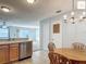 Bright kitchen area showcases stainless steel appliances, light wood cabinets, and an adjacent dining area at 2311 Pine Ridge St, The Villages, FL 32162