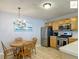 Well-lit kitchen area showcases stainless steel appliances, light wood cabinets, and an adjacent dining area at 2311 Pine Ridge St, The Villages, FL 32162