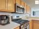 Modern kitchen with stainless steel appliances and light wood cabinetry at 2311 Pine Ridge St, The Villages, FL 32162