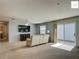 Spacious living room featuring a ceiling fan, carpeting and sliding glass doors at 2311 Pine Ridge St, The Villages, FL 32162