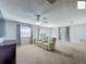 Open living room with neutral carpet, plenty of space, and lots of natural light at 2311 Pine Ridge St, The Villages, FL 32162