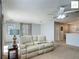 Cozy living room features a comfortable couch, neutral-toned carpet, and ample natural light at 2311 Pine Ridge St, The Villages, FL 32162