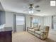 Inviting living room with comfortable seating, ceiling fan, and natural light at 2311 Pine Ridge St, The Villages, FL 32162