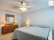 Inviting bedroom featuring a plush bed, dresser, and ceiling fan at 2311 Pine Ridge St, The Villages, FL 32162