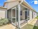 Enclosed lanai space shows multiple doorways, screened in walls, and an exterior view at 2311 Pine Ridge St, The Villages, FL 32162