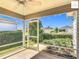 Screened-in patio with view of the landscaped backyard and neighboring homes at 2311 Pine Ridge St, The Villages, FL 32162