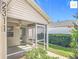 Enjoy outdoor living on this screened lanai featuring an open door, and a ceiling fan at 2311 Pine Ridge St, The Villages, FL 32162