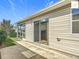 Back patio with sliding glass door at 2311 Pine Ridge St, The Villages, FL 32162