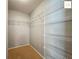 Spacious walk-in closet featuring built-in wire shelving for organized storage at 2311 Pine Ridge St, The Villages, FL 32162