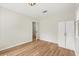 Bright bedroom featuring modern wood floors, fresh paint, and a built in closet cabinet at 2311 Vincent Rd, Orlando, FL 32817