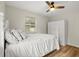 Cozy bedroom with a queen bed, hardwood floors, ceiling fan, and a spacious closet at 2311 Vincent Rd, Orlando, FL 32817